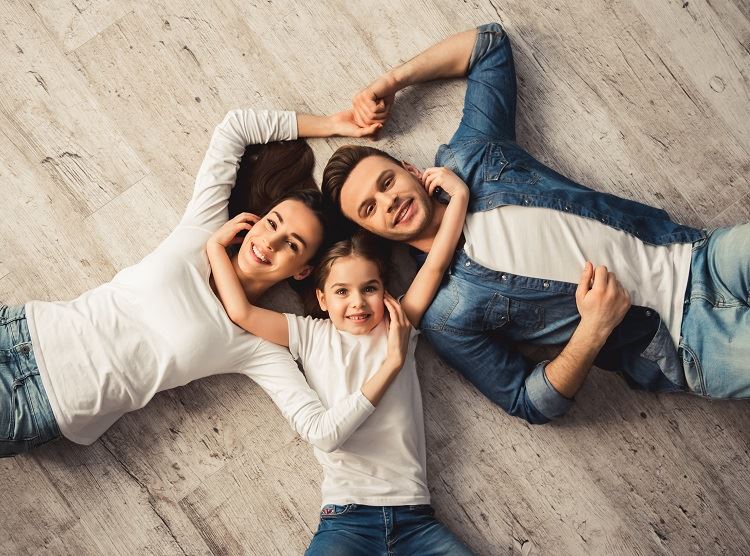 Rhode Island family laying next to each other on wooden floor